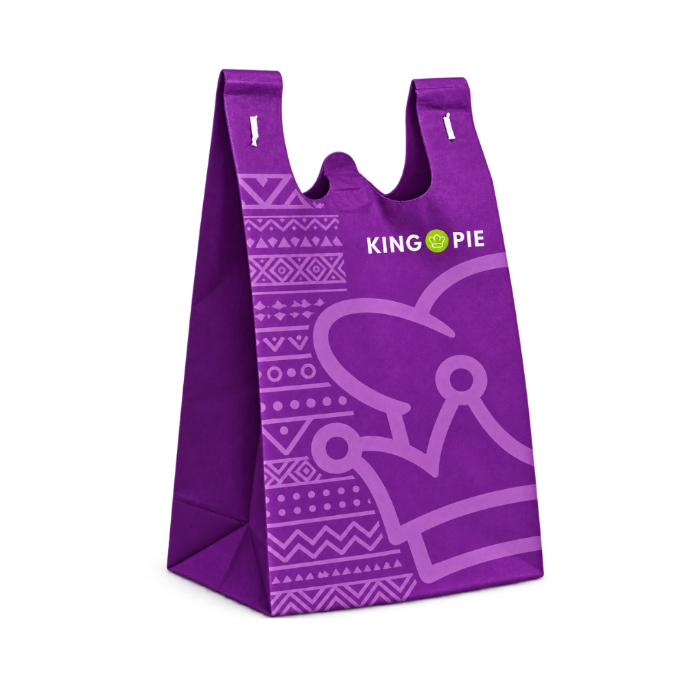 Bags Direct purple King Pie takeaway bag with integrated handles, side gussets, lilac geometric patterns, a large crown outline and white King Pie branding with a green crown emblem.