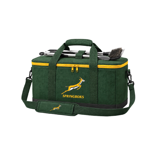 Bags Direct rectangular green Springboks cooler with yellow zips, padded carry handles, a shoulder strap and black base, with braai tools secured across the lid.