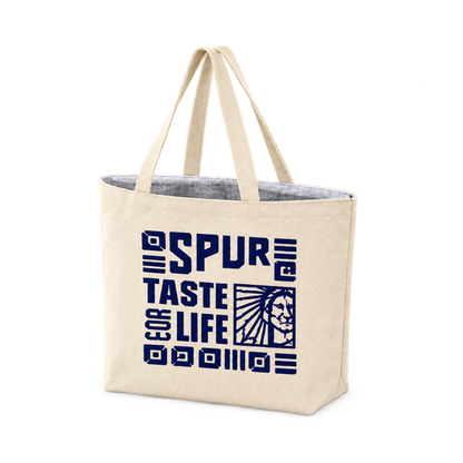 Bags Direct cream Spur cooler bag with matching handles, silver-grey insulated lining and a navy “Taste for Life” design with geometric motifs and the Spur emblem.