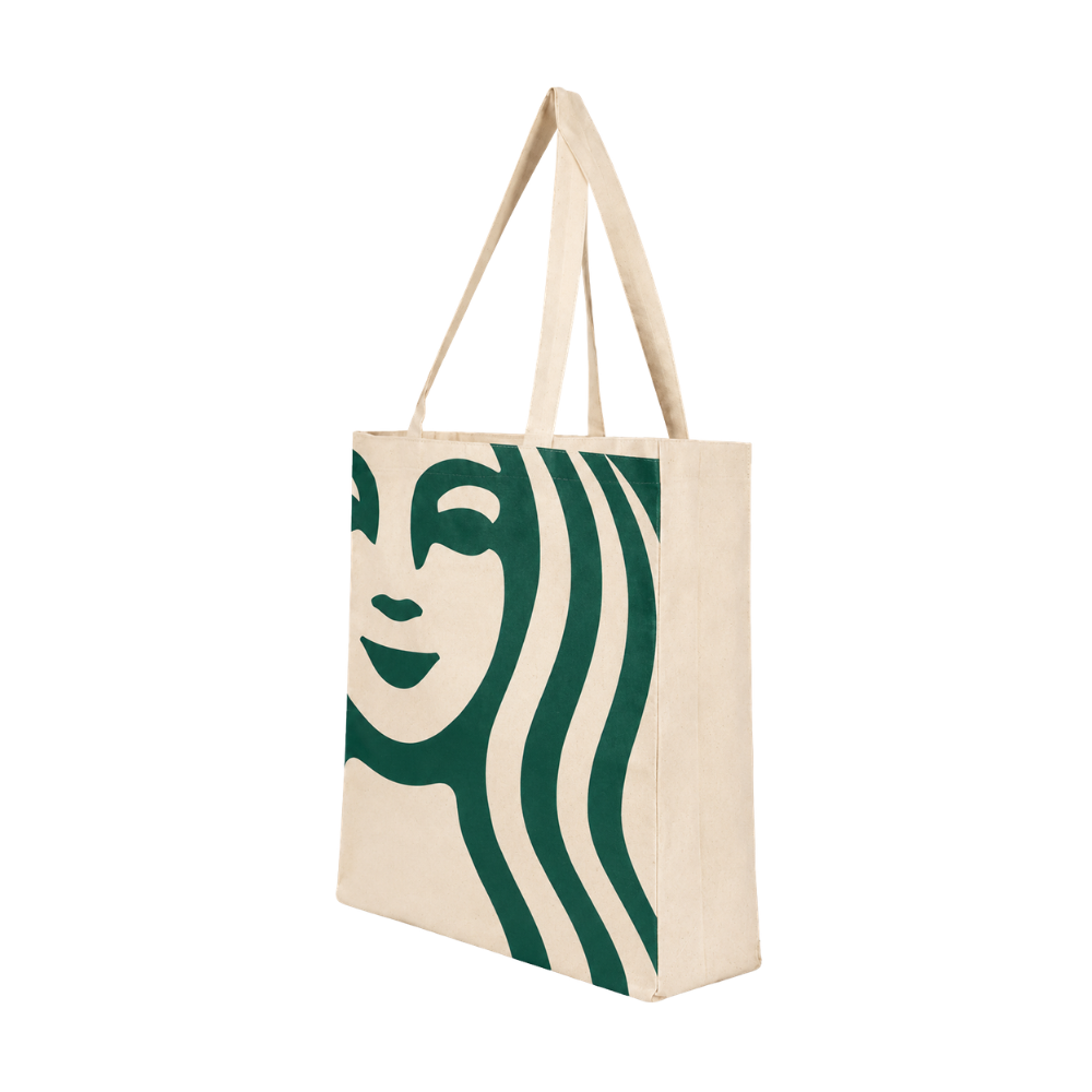 Bags Direct cream tote bag with long matching handles, a plain cream side gusset and an oversized cropped green Starbucks siren face and flowing hair across the front.